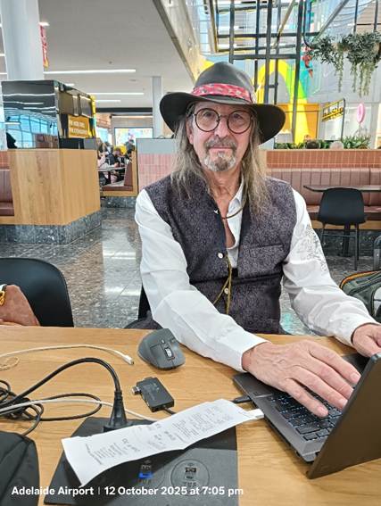 A person sitting at a table with a computer