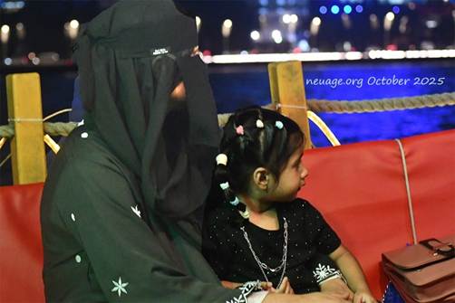 A person wearing a black veil and holding a child
AI-generated content may be incorrect.